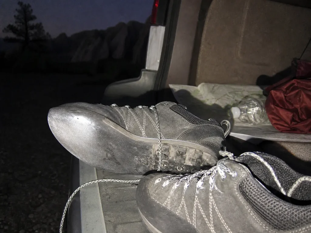 Worn approach shoe outsole photographed with camera flash at a Colorado trailhead after a scramble