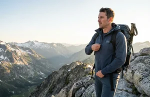 I Hiked in 9 Breathable Softshells and 3 Won Hiker in Arc'teryx softshell jacket standing on alpine ridge — best breathable softshell jackets for hiking tested