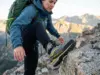 Choosing Hiking Boot Stiffness That Matches the Terrain Hiker testing boot stiffness on rocky alpine terrain using La Sportiva hiking boots