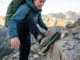 Choosing Hiking Boot Stiffness That Matches the Terrain Hiker testing boot stiffness on rocky alpine terrain using La Sportiva hiking boots
