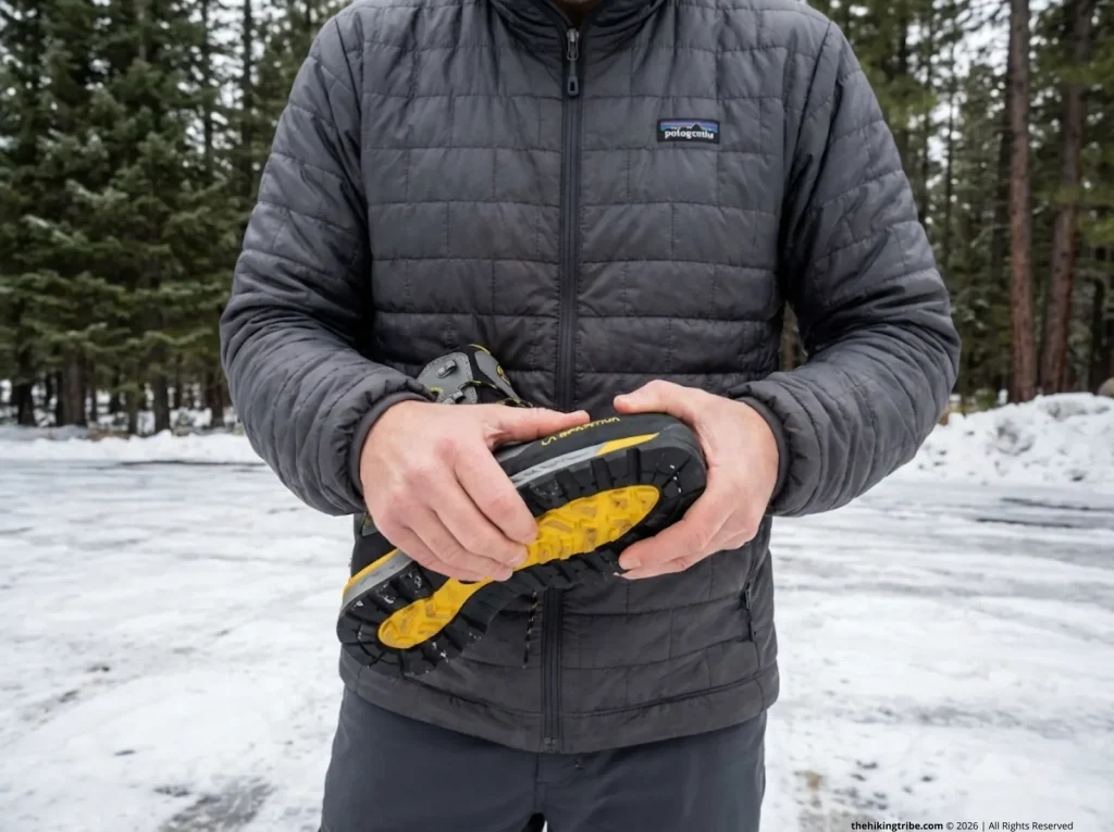 Hiker testing La Sportiva boot sole stiffness with twist test before winter hike