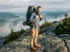Brain Lid vs Roll-Top — What Most Hikers Miss Hiker wearing an Osprey Atmos AG 65 with top-lid brain visible on a misty trail ridge