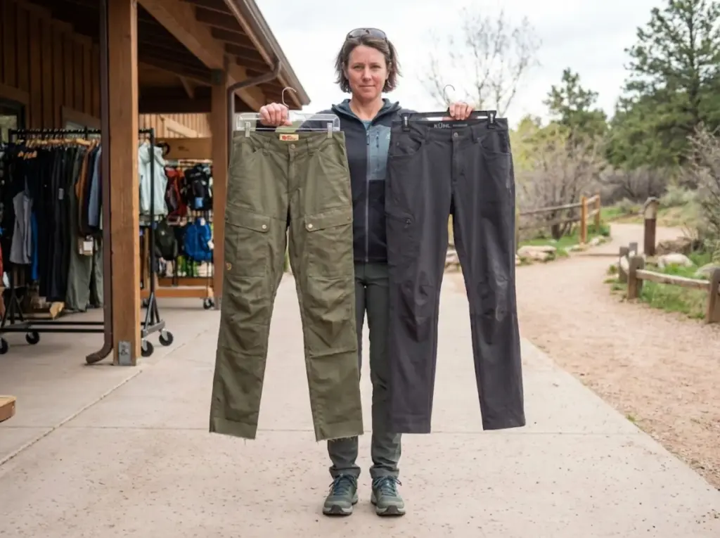 Hiker comparing raw length and fixed length hiking pants at outdoor gear shop