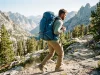 Why Cranking Load Lifters Makes Your Pack Worse Hiker on an alpine trail wearing a framed backpack with load lifter straps set at the 45-degree angle