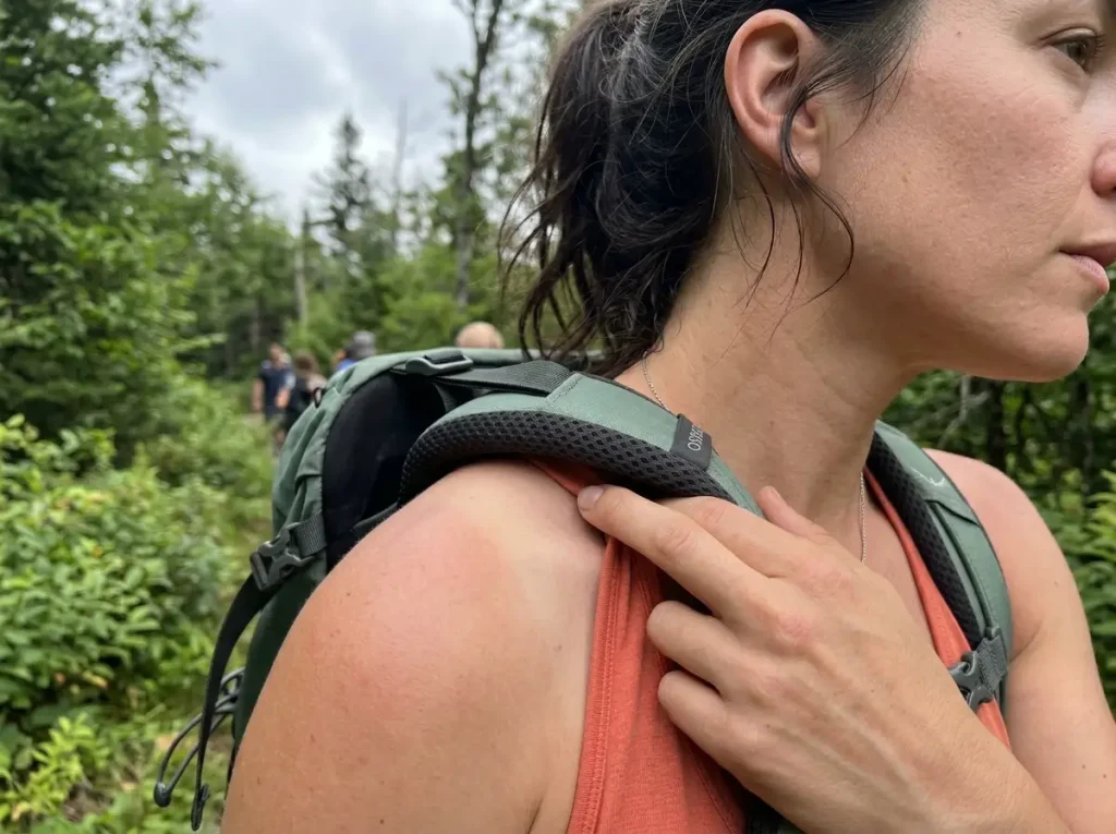 Close-up of an over-tightened load lifter strap lifting the shoulder pad away from a hiker's shoulder