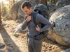 I Hiked 200 Miles Testing Snug vs Loose Base Layers Hiker adjusting Smartwool base layer fit under loaded pack on Sierra trailhead at golden hour
