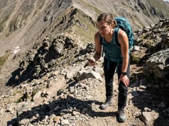 Why That “Moderate” Trail Wrecked You Last Weekend Hiker stopping on steep rocky trail checking trail difficulty rating on phone — trail difficulty rating systems