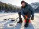 Can Your Winter Hiking Boots Handle Ice Fishing? I Tested It Hiker lacing insulated winter hiking boots on a frozen mountain lake before ice fishing
