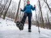 Yaktrax vs Kahtoola — One Fails on Real Ice Woman descending icy winter switchback with Kahtoola MICROspikes on Oboz boots — traction device comparison