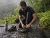 Hiking Shoes for Flat Feet Should Be Stiff Not Soft Hiking shoes for flat feet laced on a rock ledge, showing the stiff low-cut midfoot platform