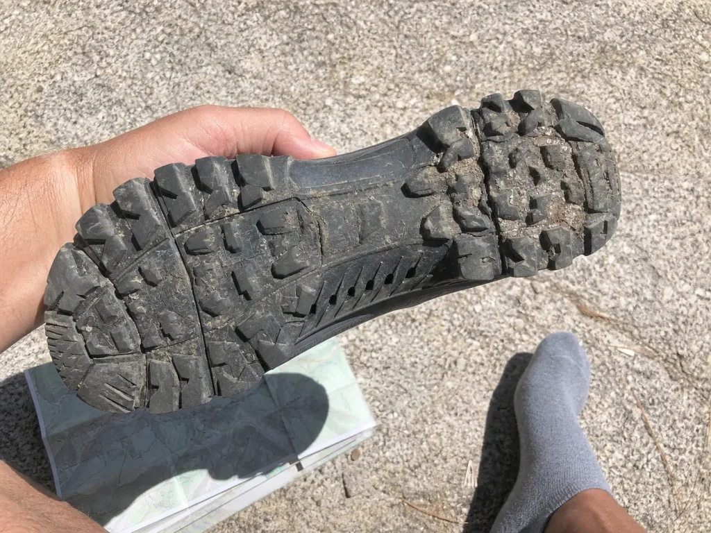 Sole and midfoot of a stiff low-cut hiking shoe, the shank structure flat feet need for support