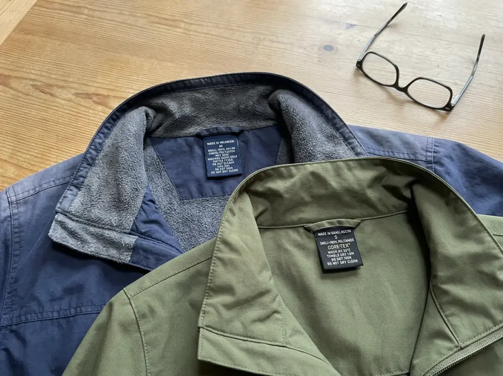 Two rain jackets side by side showing the difference between an older shell and a PFAS-free one