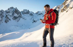 Hear That Whumpf? Avalanche Awareness Basics for Hikers Winter hiker reading avalanche awareness basics on slope angle map