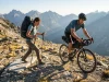 Bikepacking vs Backpacking Which Wrecks Your Body More What is bikepacking vs backpacking comparison: athletes cross paths on trail.