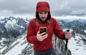 5 Map Apps for Offline Hiking Tested to Fail Hiker staring at a dead smartphone on an alpine ridge, emphasizing the risks of choosing between map apps for offline hiking.