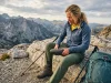 How to Tell When Hiking Shoes Are Worn Out (The Press Test) Female hiker performing the Press Test on worn hiking shoes to check for midsole failure.