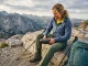 How to Tell When Hiking Shoes Are Worn Out (The Press Test) Female hiker performing the Press Test on worn hiking shoes to check for midsole failure.