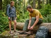 Boots vs Shoes vs Sandals? A Field-Tested Breakdown Two hikers contrasting heavy Lowa boots and minimalist Bedrock sandals on forest trail.
