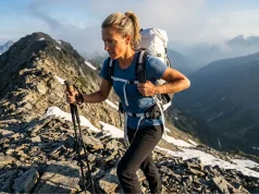 Hiking Gear Weight vs Comfort Solved After 7 Days Out Female hiker adjusting a Hyperlite Mountain Gear backpack on a scree ridge, illustrating the hiking gear weight vs comfort tradeoff.