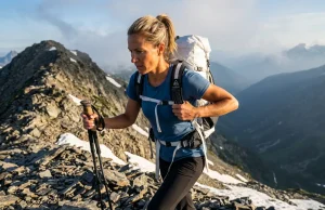 Hiking Gear Weight vs Comfort Solved After 7 Days Out Female hiker adjusting a Hyperlite Mountain Gear backpack on a scree ridge, illustrating the hiking gear weight vs comfort tradeoff.