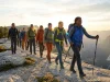 After Leading 50+ Group Hikes, This is What Actually Works Diverse hiking group moving along a mountain ridgeline led by an experienced hike leader