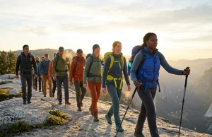 After Leading 50+ Group Hikes, This is What Actually Works Diverse hiking group moving along a mountain ridgeline led by an experienced hike leader
