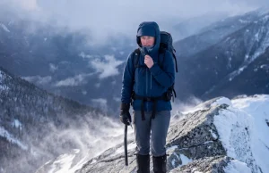 What Most Hikers Get Wrong About Frostbite Female hiker adjusting jacket to prevent frostbite on a frozen winter ridge