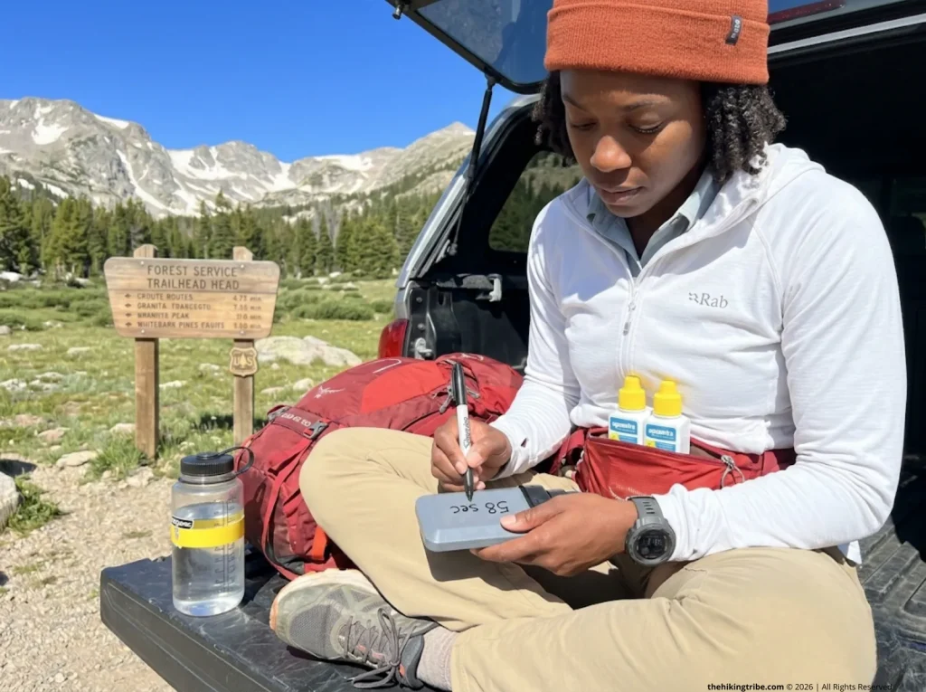 Experienced hiker drying Sawyer filter in tent vestibule before storage  