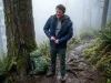 Why Most Hikers Ditch 3 in 1 Jackets After One Season Hiker on a misty trail removing a bulky 3-in-1 jacket mid-hike