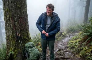 Why Most Hikers Ditch 3 in 1 Jackets After One Season Hiker on a misty trail removing a bulky 3-in-1 jacket mid-hike