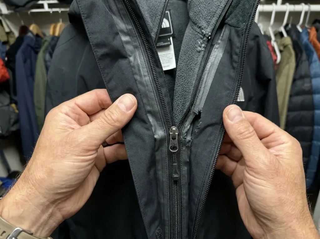 Close-up of a 3-in-1 jacket zip-in connection system showing the liner attachment