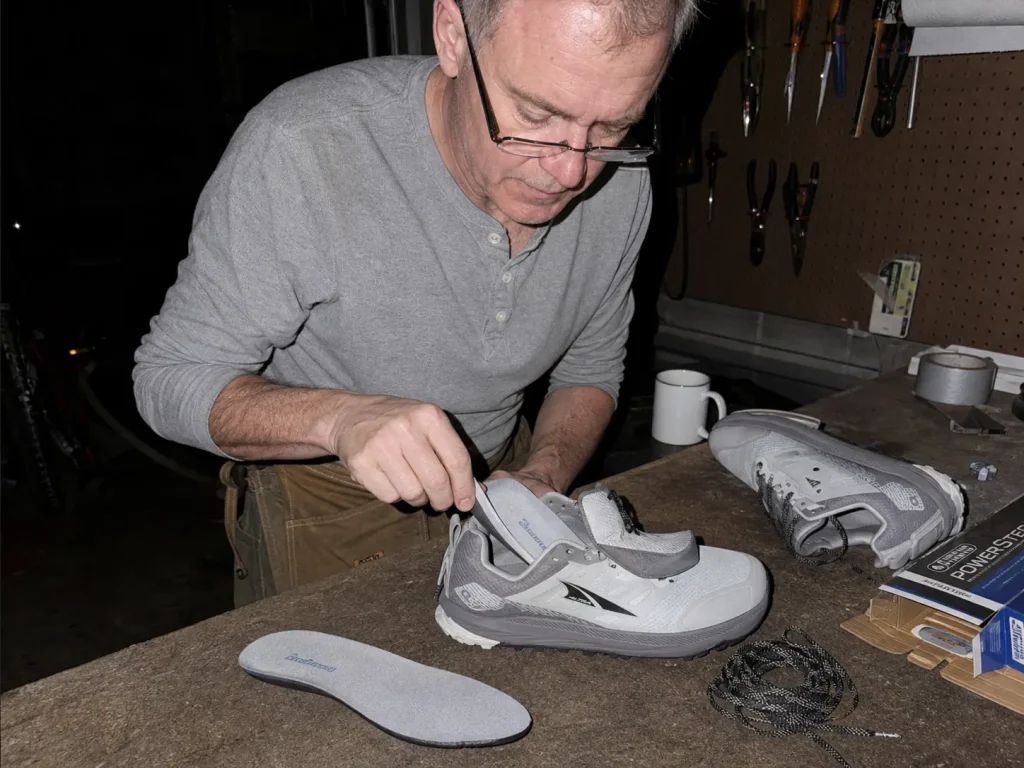 Swapping the insole in a hiking shoe at night to gain forefoot room for wide feet