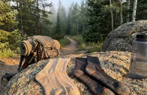 Bamboo vs Merino Hiking Socks Field Tested and Ranked Bamboo and merino hiking socks side by side on a rocky trail at sunrise
