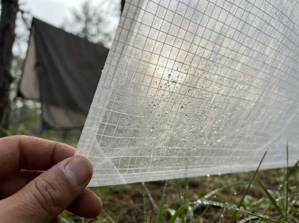Close-up of DCF Dyneema tent fabric texture showing translucent weave pattern