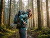 How to Attach Gear Outside Your Pack So It Never Falls Backpacker with gear lashed to the outside of a loaded Osprey pack on a forest trail