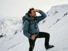 How to Read Snow Conditions for Safe Travel Hiker reading snow conditions on alpine slope — how to read snow for safe winter travel