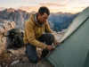 How to Repair a Tent Zipper on Trail Fast Backpacker repairing a broken tent zipper with a multi-tool on a mountain ledge during dusk.