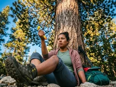 How to Treat Insect Stings With Allergic Reaction on Trail Hiker on trail preparing to use EpiPen for insect sting allergic reaction in subalpine forest