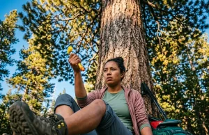 How to Treat Insect Stings With Allergic Reaction on Trail Hiker on trail preparing to use EpiPen for insect sting allergic reaction in subalpine forest