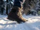 Best Insulated Winter Hiking Boots Worth the Money Close-up of an insulated winter hiking boot stepping into fresh snow on a frozen alpine trail at golden hour