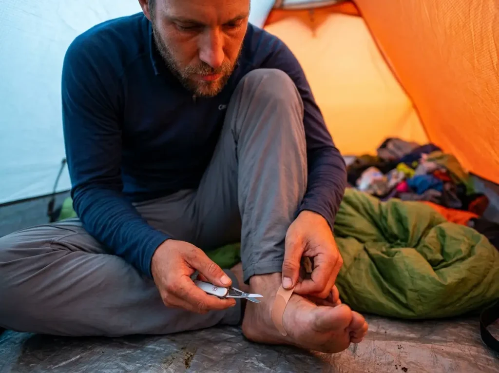 Applying Leukotape P in tent for morning foot hardening protocol