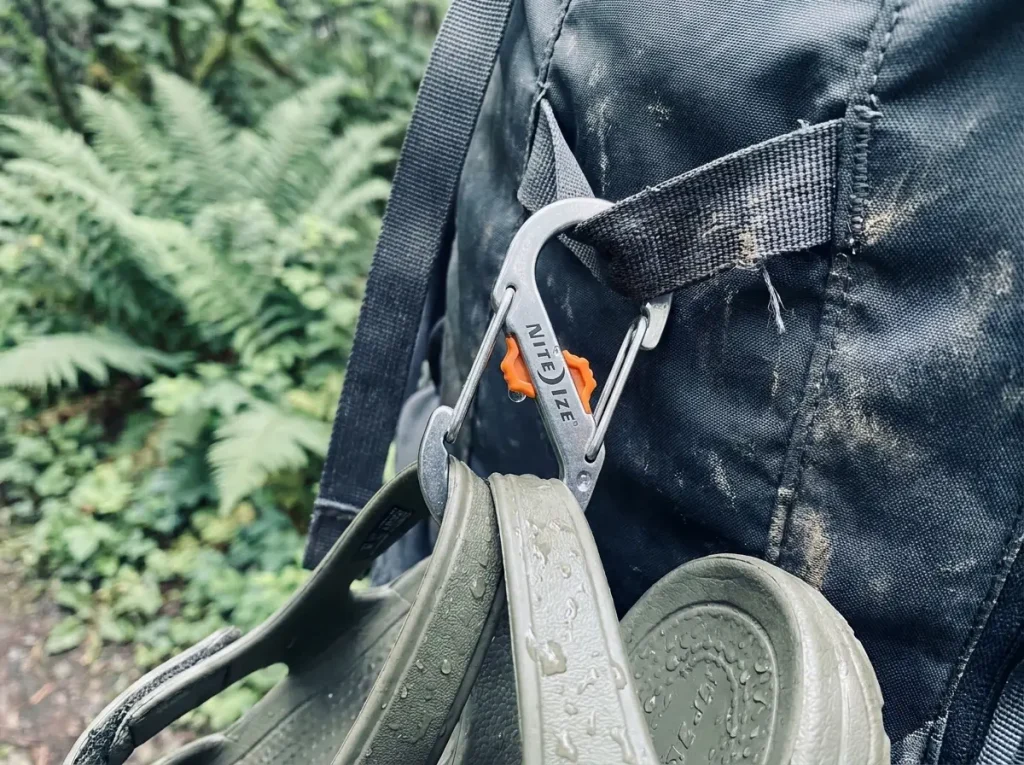 Nite Ize S-Biner SlideLock locking carabiner clipped to a backpack daisy chain loop