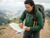 How to Plan a Route Using Contour Lines and Save Your Knees Female hiker planning a safe route using contour lines on a paper topographic map