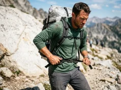 Section Hiking vs Thru Hiking Pros and Cons — The Hard Data Hiker adjusting heavy backpack on trail comparing section and thru hiking pros and cons