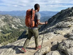 4 Times One Trekking Pole Beats a Pair on Trail Hiker using a single trekking pole on a rocky alpine trail with mountain views