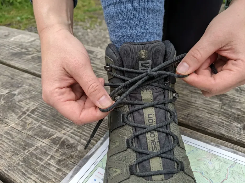 Close-up of surgeon's knot lacing technique on hiking boot