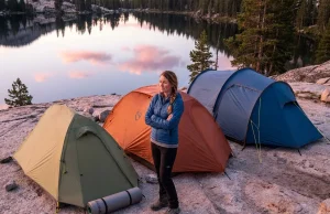 Tent Weight Buying Guide What the Specs Hide Backpacking tents of different sizes set up at a mountain campsite at dawn