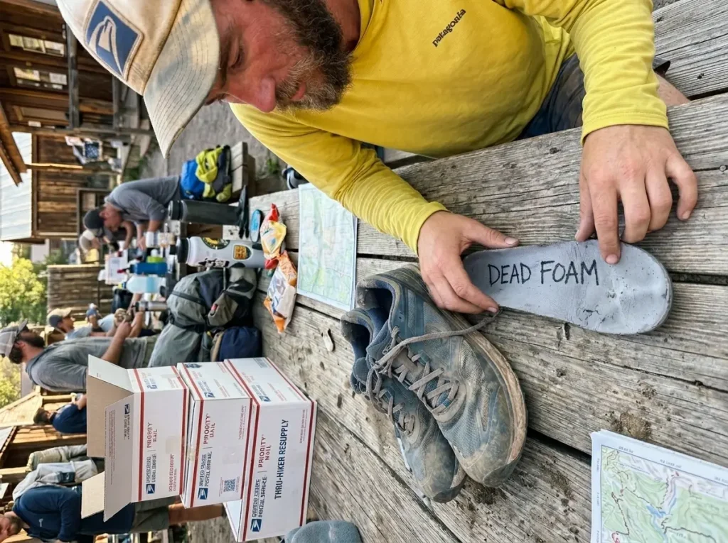 Thru-hiker testing a worn-out Currex insole for compression set failure.