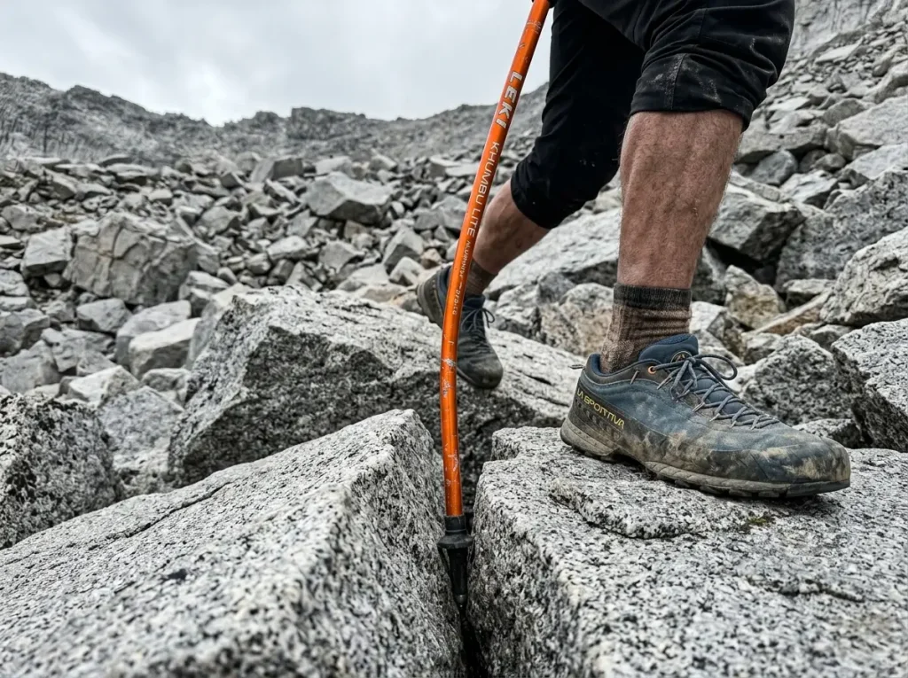 Aluminum trekking pole safely bending while wedged in rocks