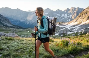 4 Best Ultralight Backpacks Under 2 Pounds 2026 Thru-hiker with ultralight backpack crossing an alpine meadow at sunrise